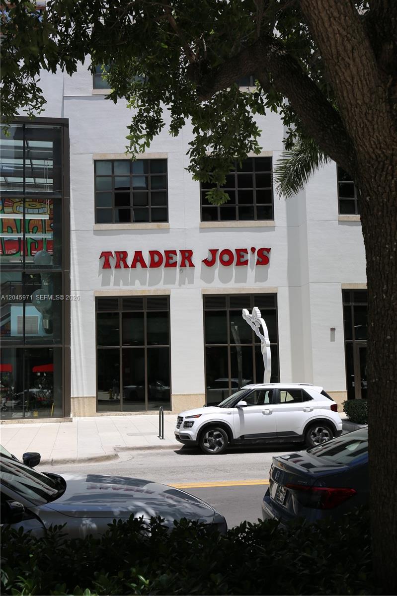 A white building with a Trader Joe's sign stands behind a parked white SUV — 90 NE 32nd St # 702, Miami FL 33137, MIAMI, FL