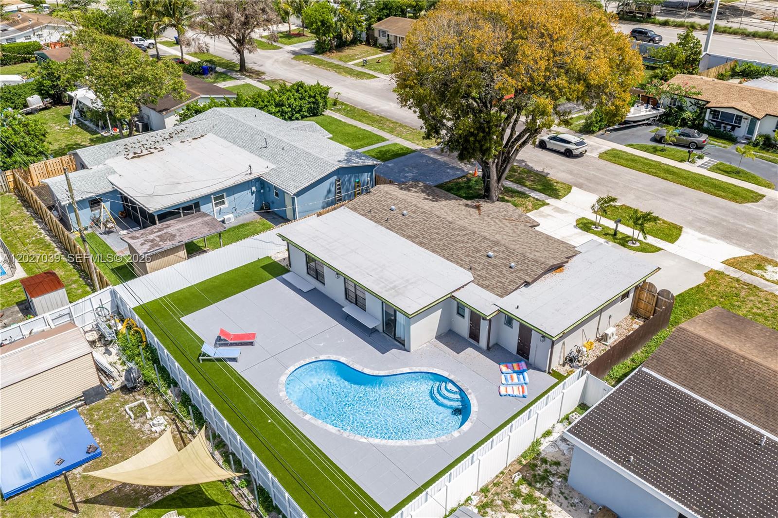 An aerial view shows a house with a backyard pool, patio, and artificial turf — 7051 Tyler St, Hollywood FL 33024, HOLLYWOOD, FL