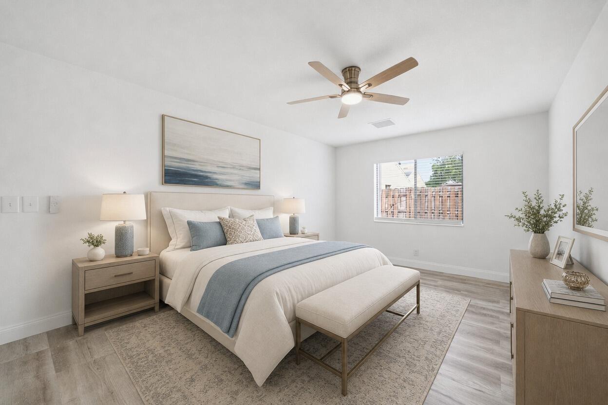 A bedroom features a bed with blue accents, a ceiling fan, and light wood furniture — 905 NW 22nd Avenue, Delray Beach FL 33445, DELRAY BEACH, FL