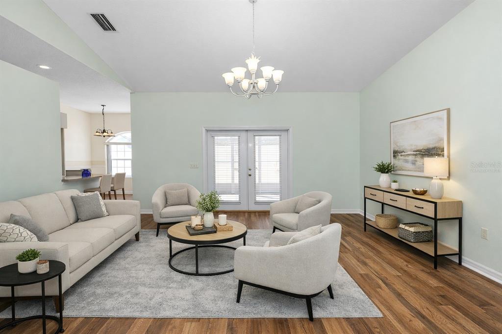 A living room features light-colored furniture, a round coffee table, and a console table — 2258 COLONY CLUB DRIVE, LAKELAND, FL
