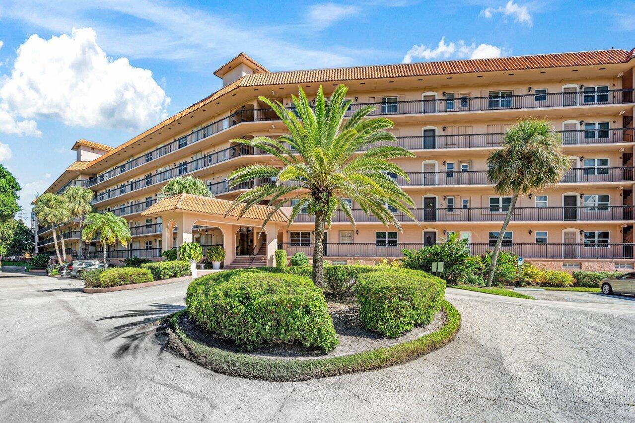 A multi-story apartment building with a circular driveway, palm trees, and a covered entrance — 2871 N Ocean Boulevard # C417, Boca Raton FL 33431, BOCA RATON, FL