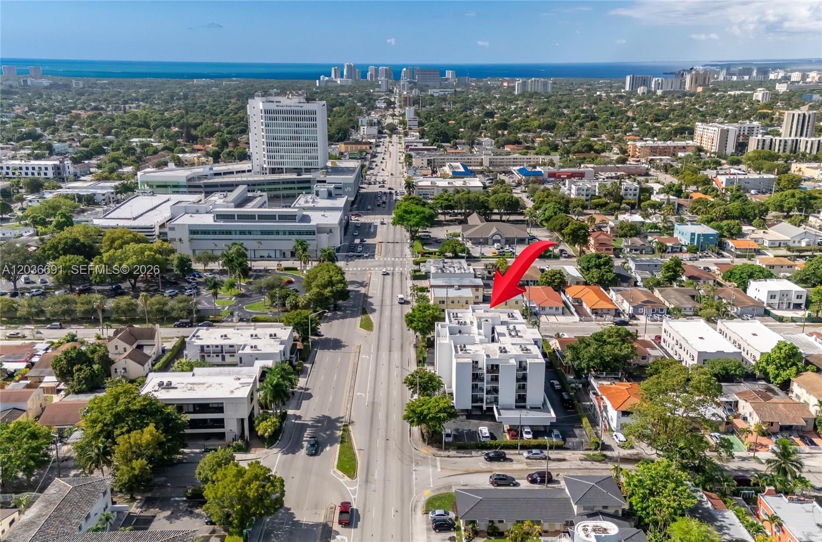An aerial view shows a multi-story white apartment building highlighted by a red arrow — 444 SW 27th Ave # 50, Miami FL 33135, MIAMI, FL