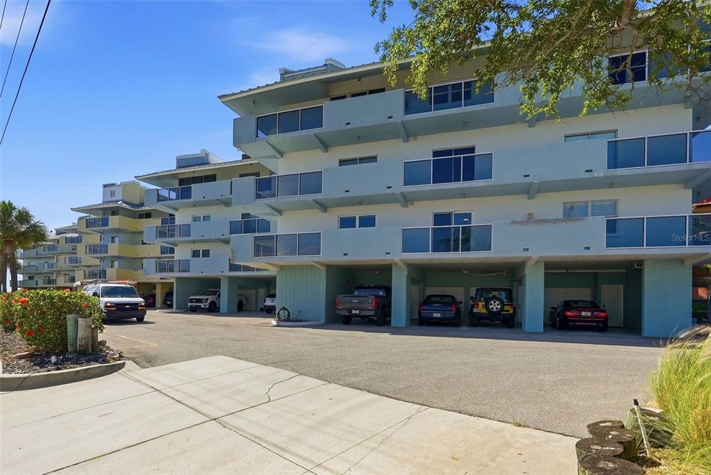 A multi-story apartment building with covered parking on the ground level and exterior balconies — 1100 PINELLAS BAYWAY S UNIT G2, TIERRA VERDE, FL
