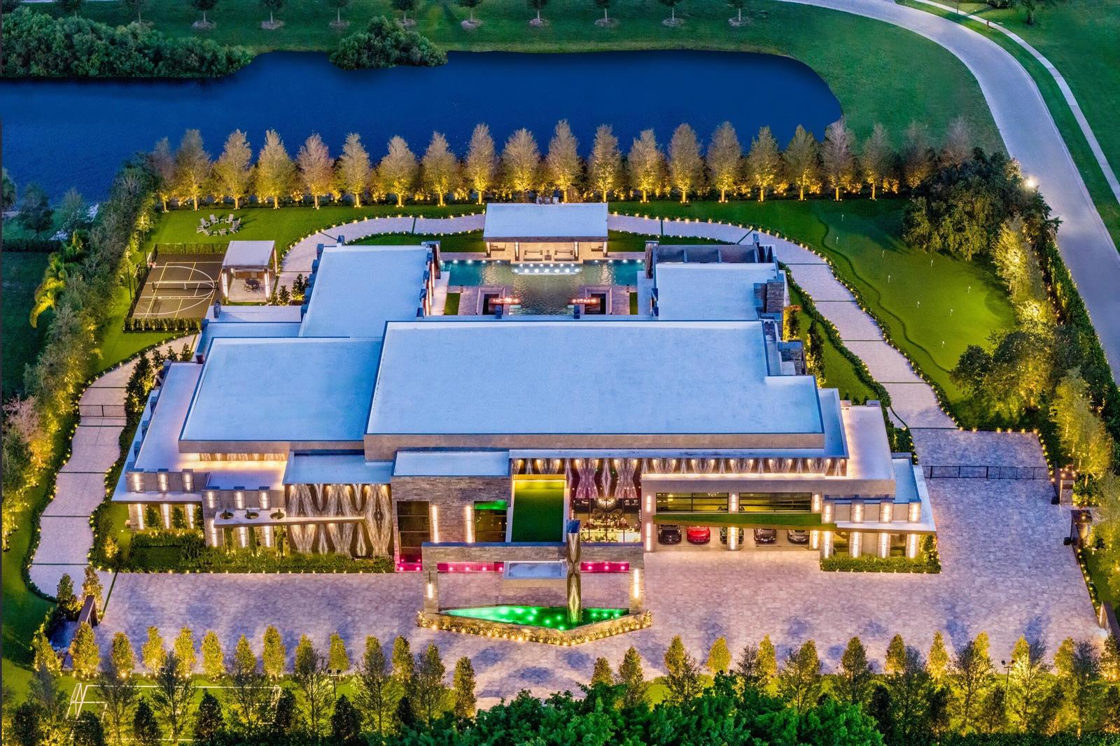 An aerial view of a large modern mansion featuring a pool, basketball court, and putting green — 16121 Quiet Vista Circle, Delray Beach FL 33446, DELRAY BEACH, FL