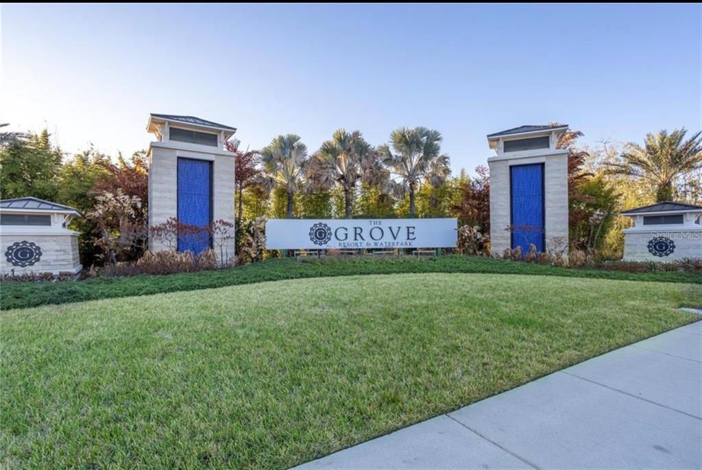 The entrance sign for The Grove Resort & Waterpark features stone pillars with blue accents — 14501 GROVE RESORT AVENUE UNIT 2615, WINTER GARDEN, FL