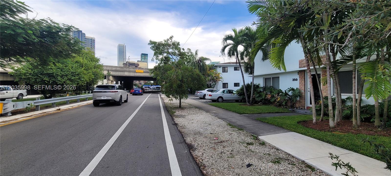 A street view shows a white building with palm trees next to a road underpass — 350 SW 15th Rd # 9, Miami FL 33129, MIAMI, FL
