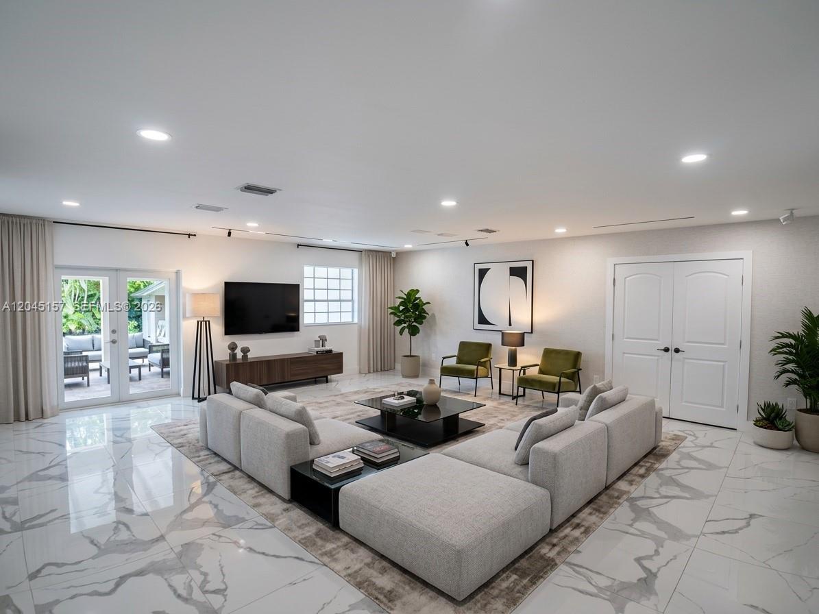 A single-story house with a white exterior, arched porch, and paved driveway at night — 8240 SW 38th St, Miami FL 33155, MIAMI, FL