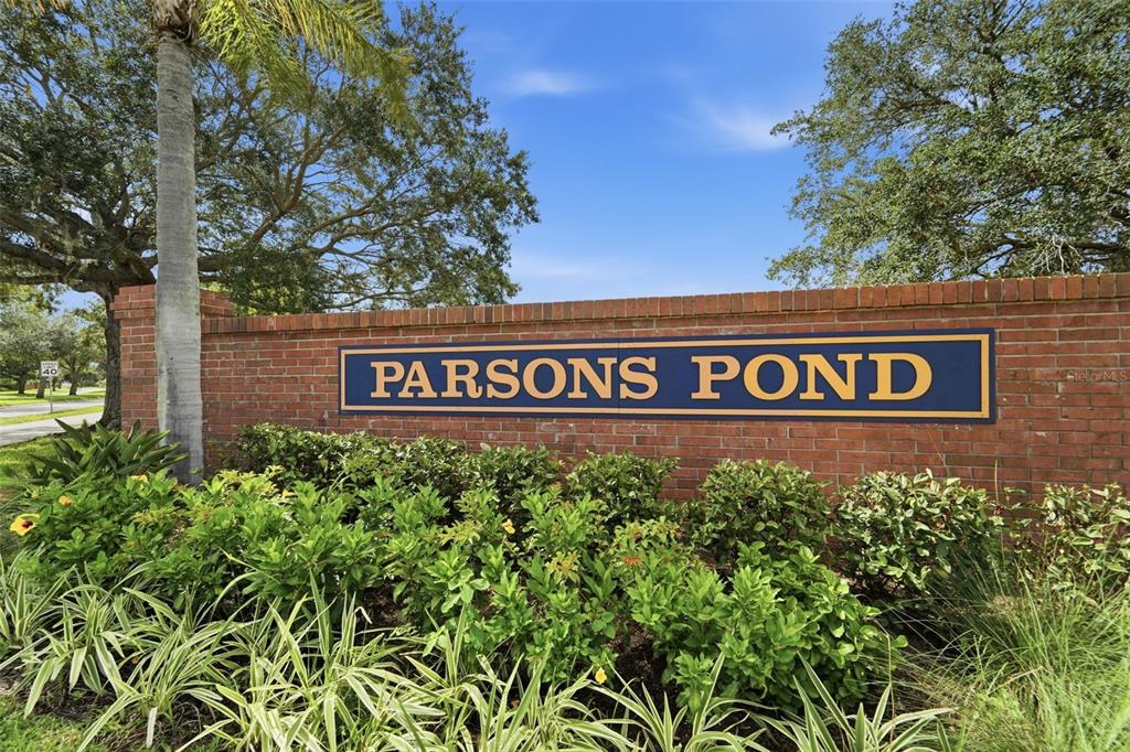 A brick wall with a sign reading Parsons Pond stands in front of green landscaping — 2411 PARSONS POND CIRCLE, KISSIMMEE, FL