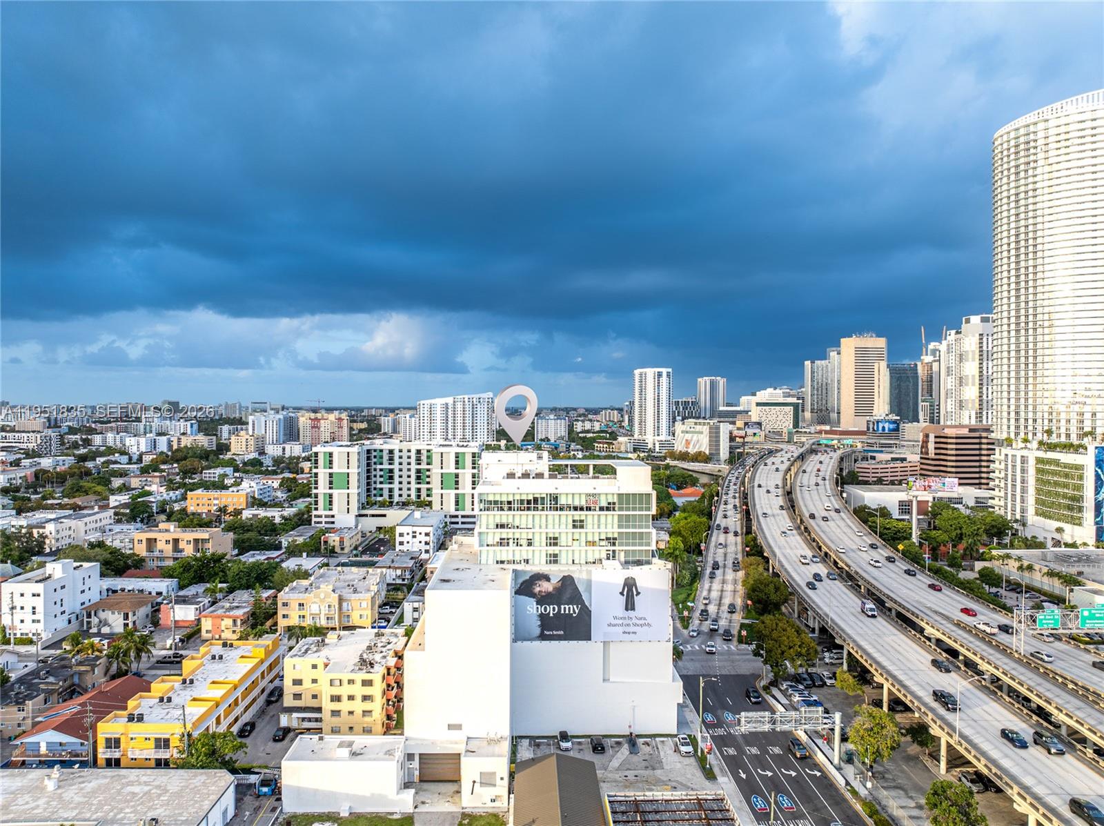 An aerial view shows a city skyline with a highway, residential buildings, and a billboard — 420 SW 7th St # 1214, Miami FL 33130, MIAMI, FL