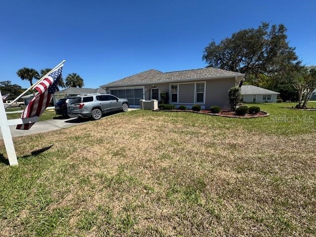 A single-story house with a gray exterior and a silver SUV parked in the driveway — 11299 SW 71ST TERRACE ROAD, OCALA, FL