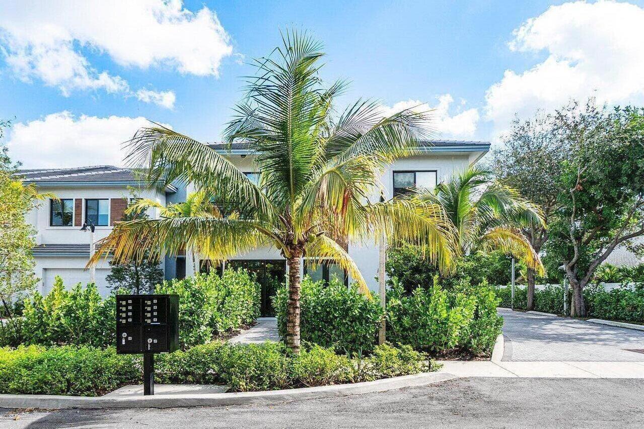 A two-story house exterior features a central palm tree, a black mailbox, and paved driveway — 2211 Florida Boulevard # A, Delray Beach FL 33483, DELRAY BEACH, FL