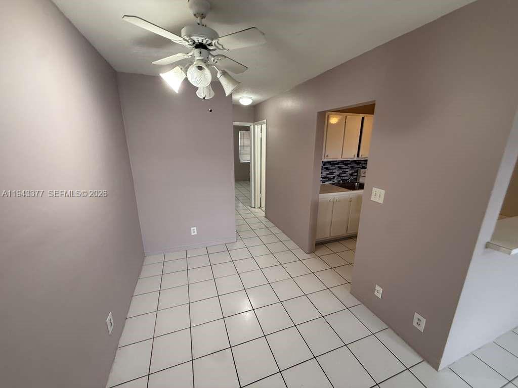 A dining area features white tile flooring, light-colored walls, and a ceiling fan — 2916 Funston St # 53A, Hollywood FL 33020, HOLLYWOOD, FL