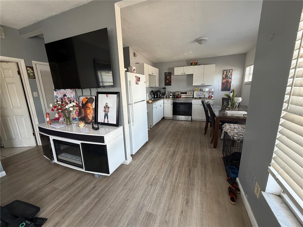 A single-story house with a gravel driveway, a parked truck, and a white privacy fence — 2318 W POWHATAN AVENUE, TAMPA, FL