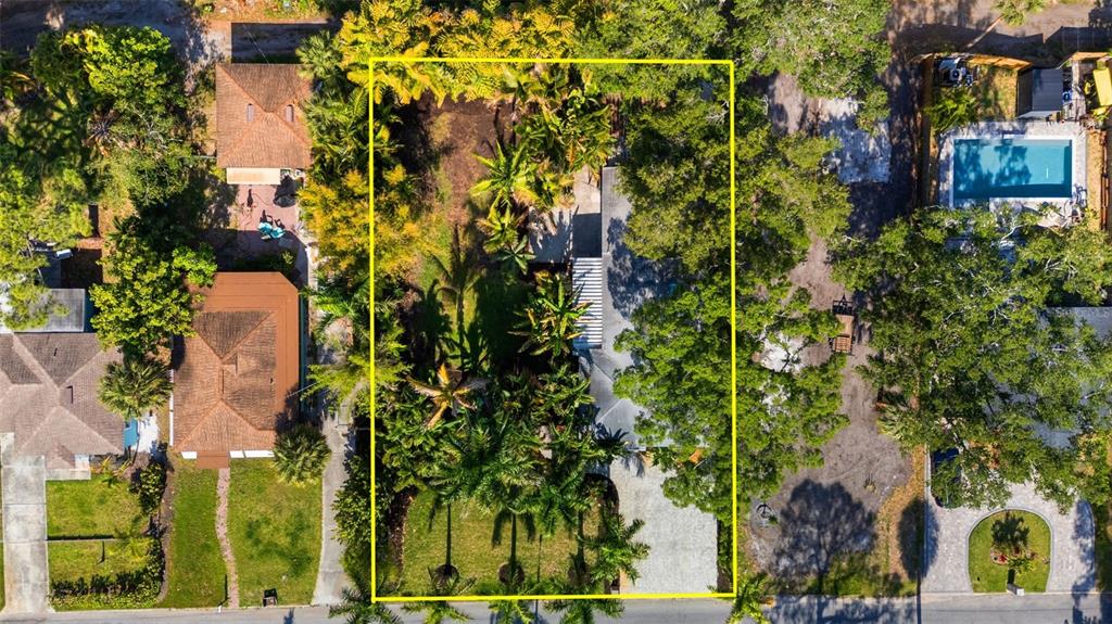 An aerial view shows a residential property with a house, lush landscaping, and a driveway — 2657 44TH STREET S, GULFPORT, FL