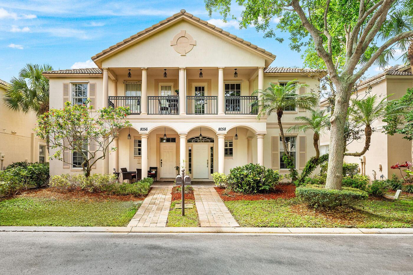 A two-story duplex building with a symmetrical facade, columns, balconies, and two front entrances — 8058 Murano Circle, Palm Beach Gardens FL 33418, PALM BEACH GARDENS, FL