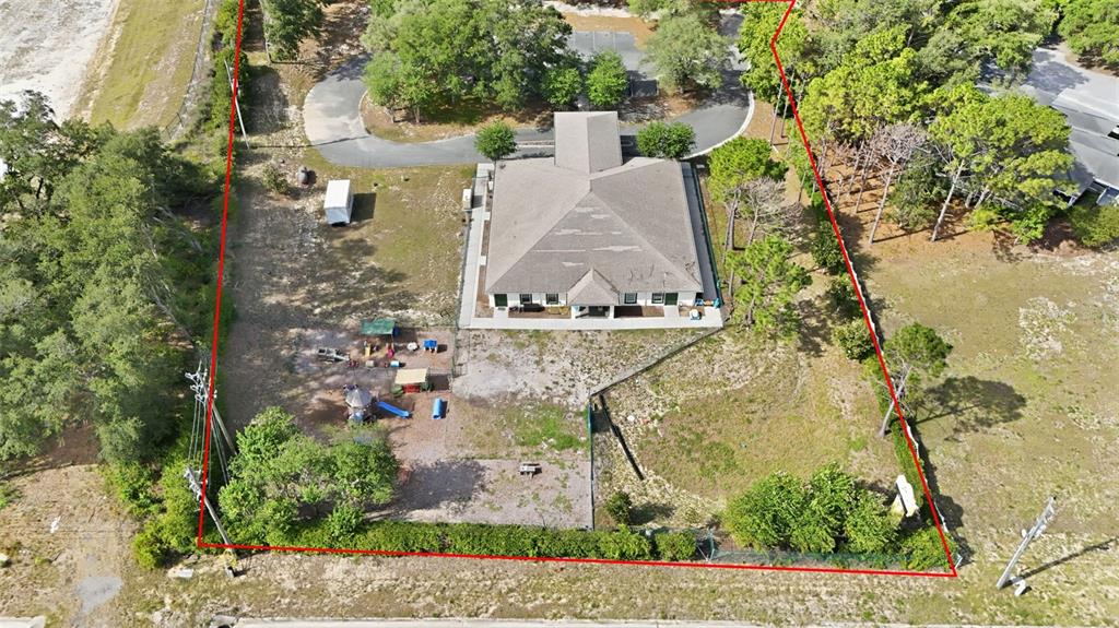An aerial view shows a building with a playground and parking lot on a lot — 20540 INDEPENDENCE BOULEVARD, GROVELAND, FL