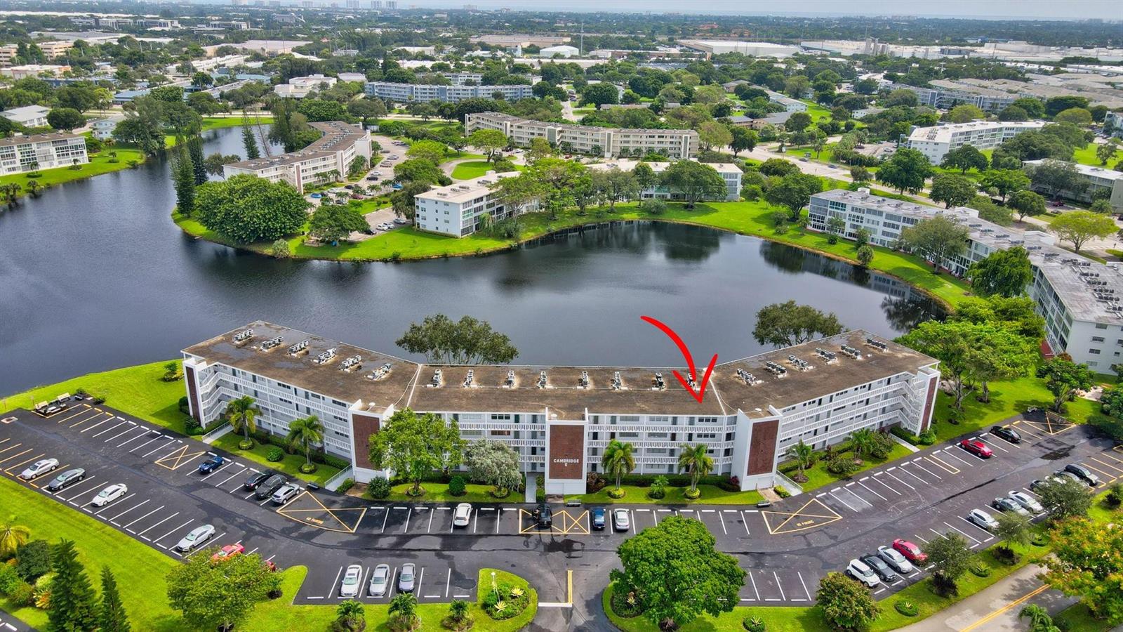 An aerial view shows a multi-story apartment building with a red arrow pointing to a unit — 3107 Cambridge # 3107, Deerfield Beach FL 33442, DEERFIELD BEACH, FL
