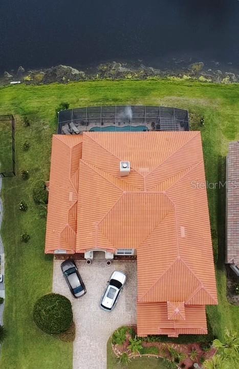 A two-story stucco house with a tile roof, a paved driveway, and a mailbox — 2604 HERITAGE GREEN AVENUE, DAVENPORT, FL