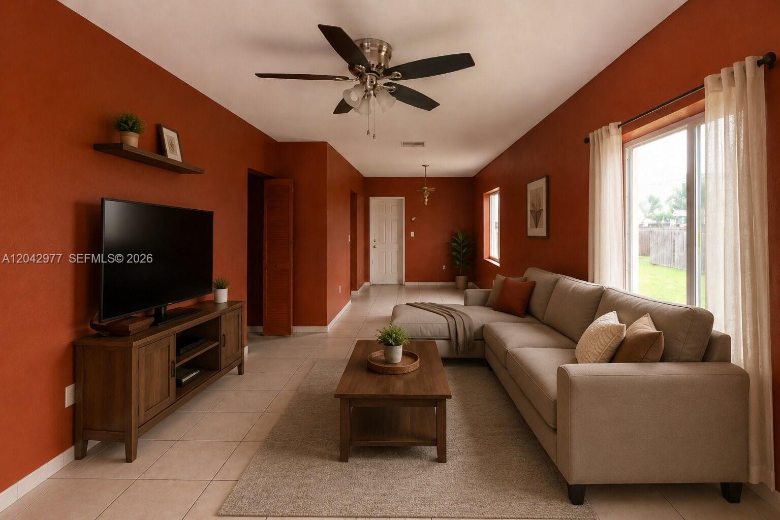 A living room features terracotta walls, a beige sectional sofa, and a wooden media console — 420 NW 84th Ter # 420, Miami FL 33150, MIAMI, FL