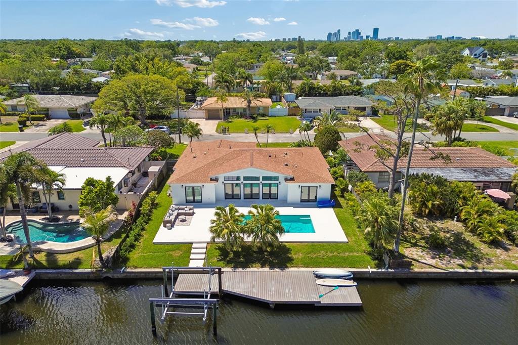 An aerial view of a waterfront house with a swimming pool, patio, and private dock — 797 45TH AVENUE NE, ST PETERSBURG, FL