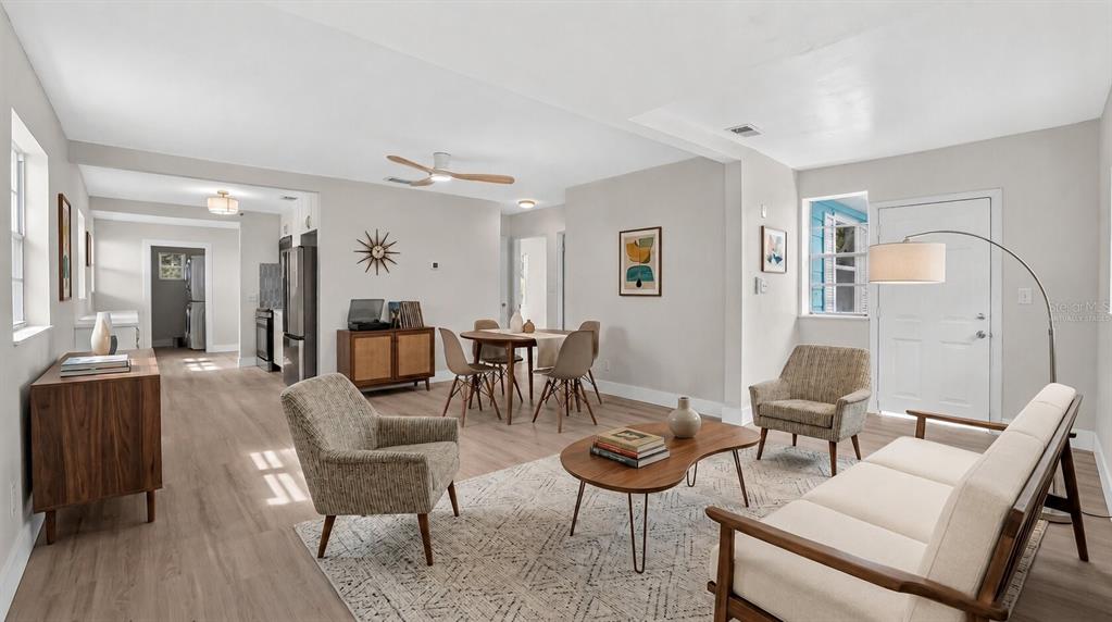 A living room with light wood flooring, a dining area, and neutral-toned furniture — 2960 EMERSON AVENUE S, ST PETERSBURG, FL