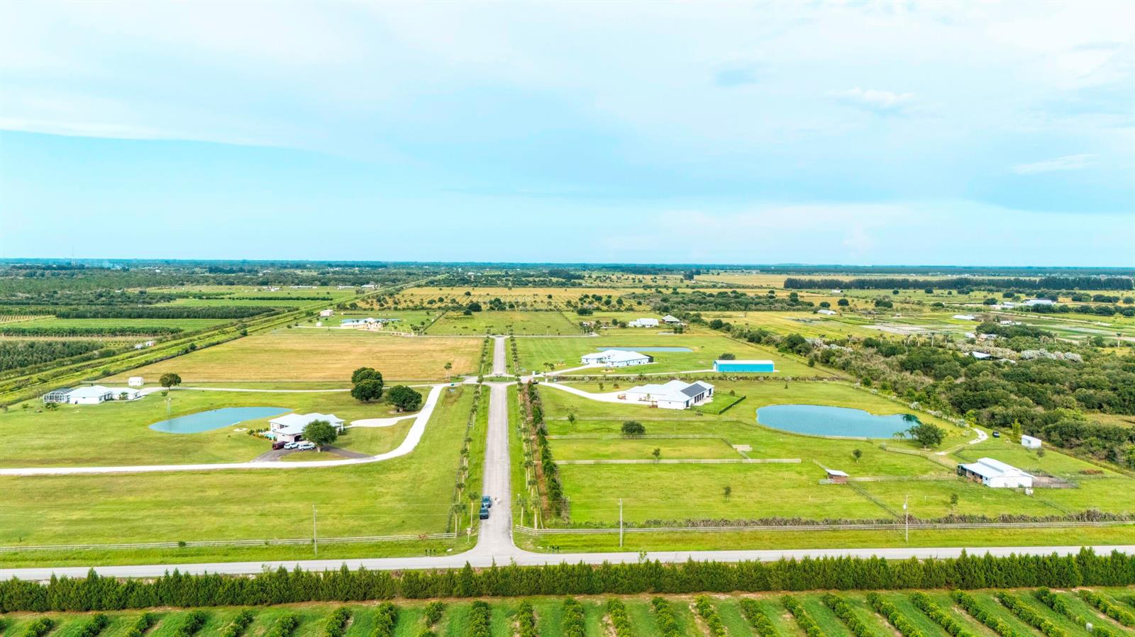 An aerial view shows several houses with ponds and fenced pastures on a rural property — 4 Sneed Road, Fort Pierce FL 34945, FORT PIERCE, FL