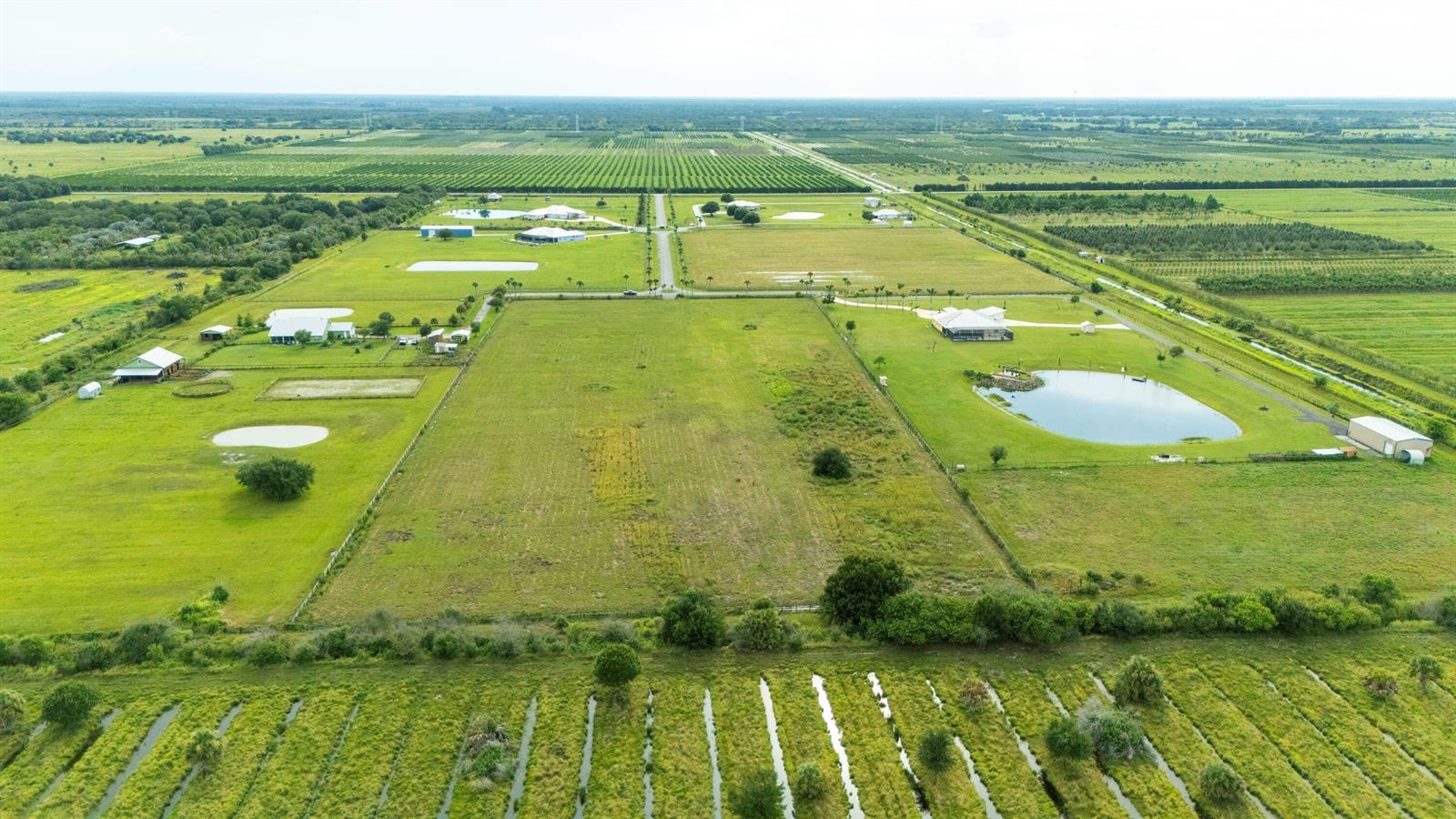 An aerial view shows a large rural property with multiple houses, ponds, and surrounding farmland — 4 Sneed Road, Fort Pierce FL 34945, FORT PIERCE, FL