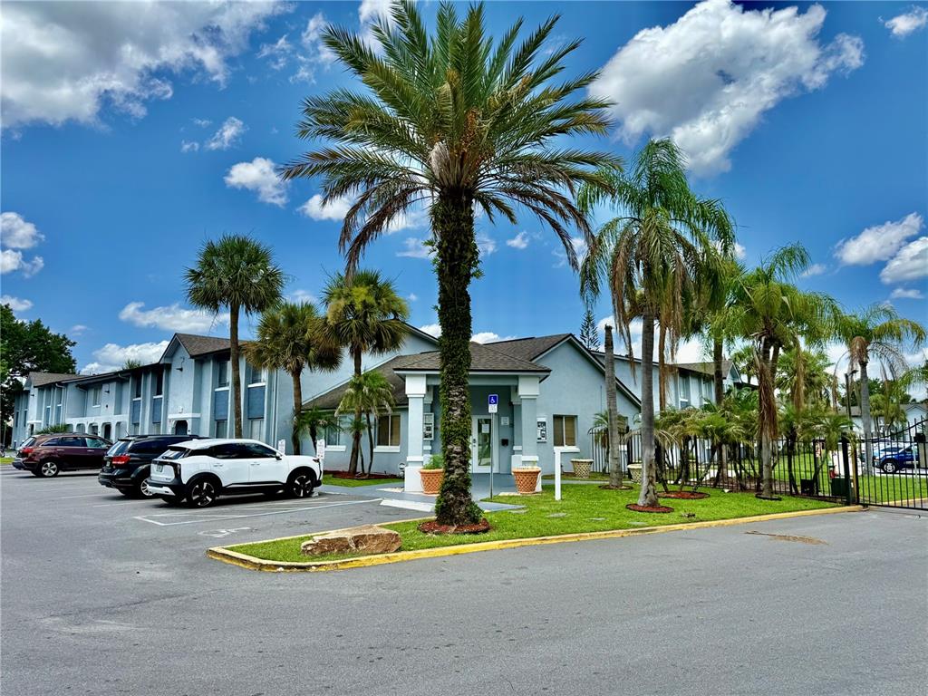 A light blue two-story building with palm trees and a parking lot in front — 4805 S TEXAS AVENUE UNIT 4805C, ORLANDO, FL