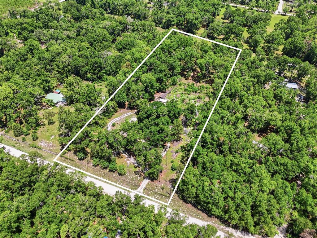 An aerial view shows a rectangular plot of land outlined in white amidst dense trees — 12725 212TH TERRACE, O'BRIEN, FL