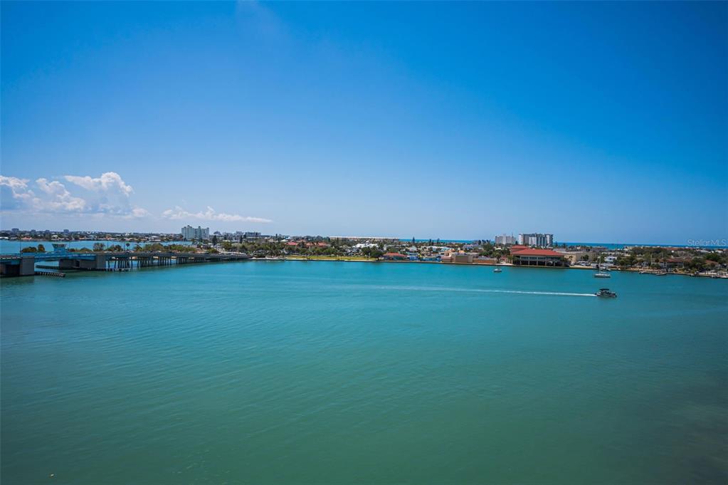 An aerial view of a blue bay with a bridge and coastal buildings — 7882 SAILBOAT KEY BOULEVARD S UNIT 605, SOUTH PASADENA, FL
