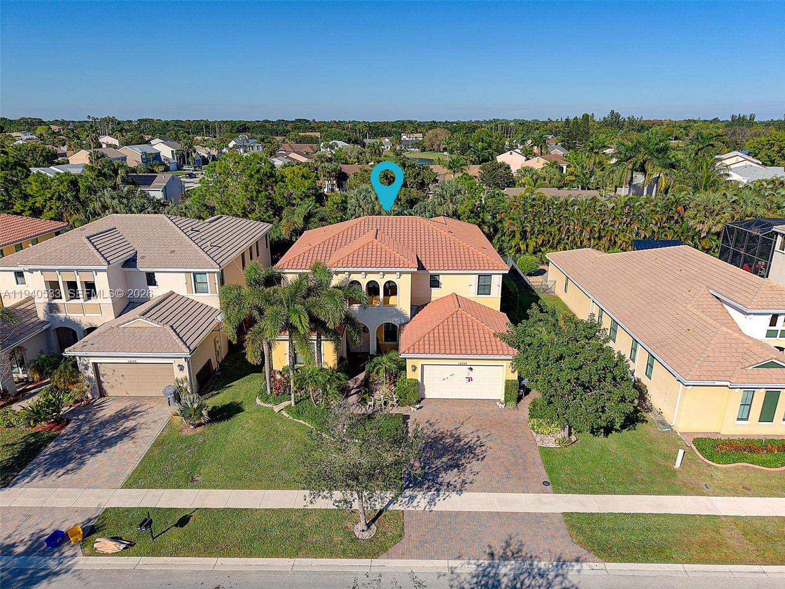 An aerial view shows a two-story suburban house with a tiled roof and driveway — 12097 Boca Reserve Ln, Boca Raton FL 33428, BOCA RATON, FL