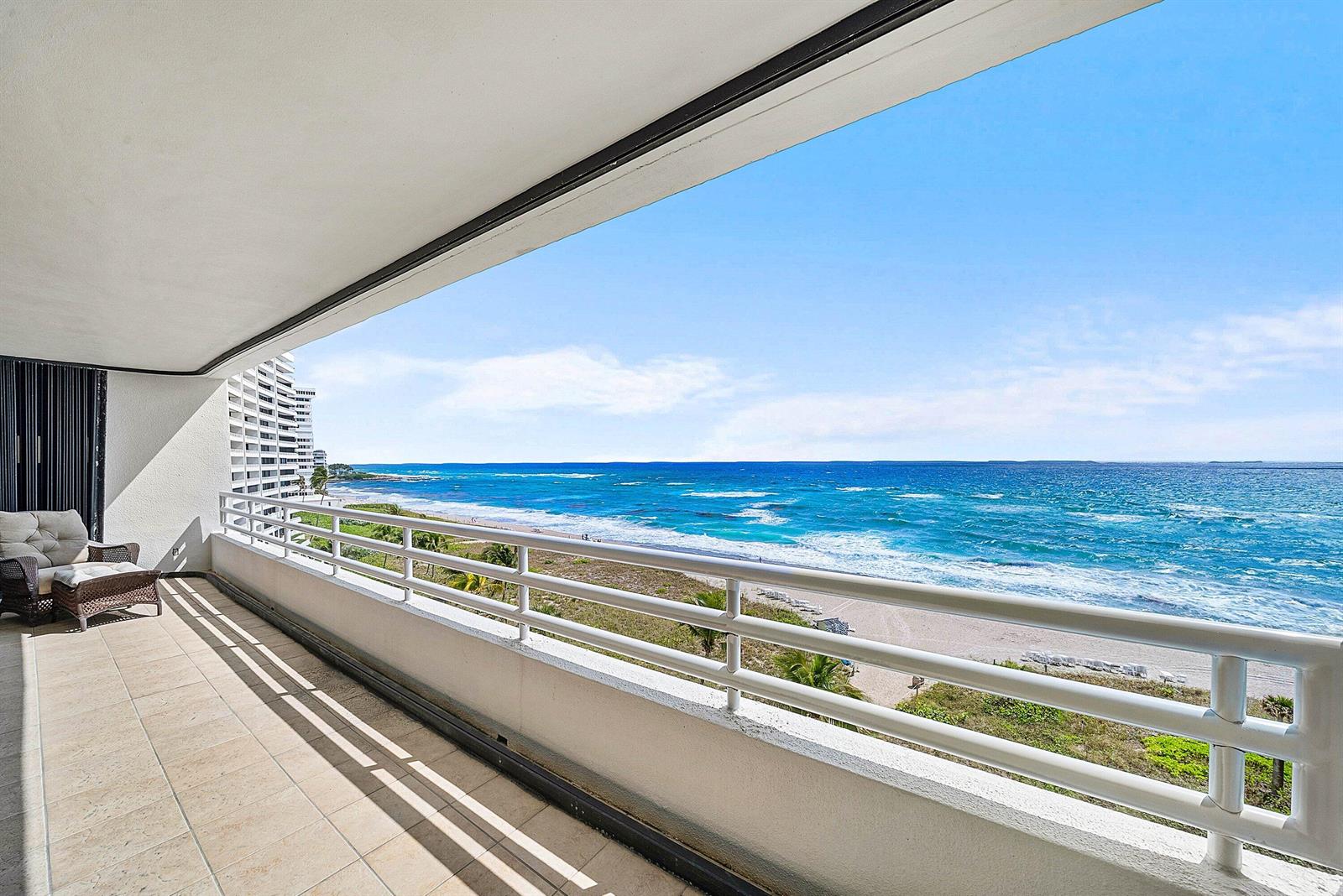 A tiled balcony overlooks a sandy beach and the blue ocean under a clear sky — 1500 S Ocean Boulevard # 604, Boca Raton FL 33432, BOCA RATON, FL