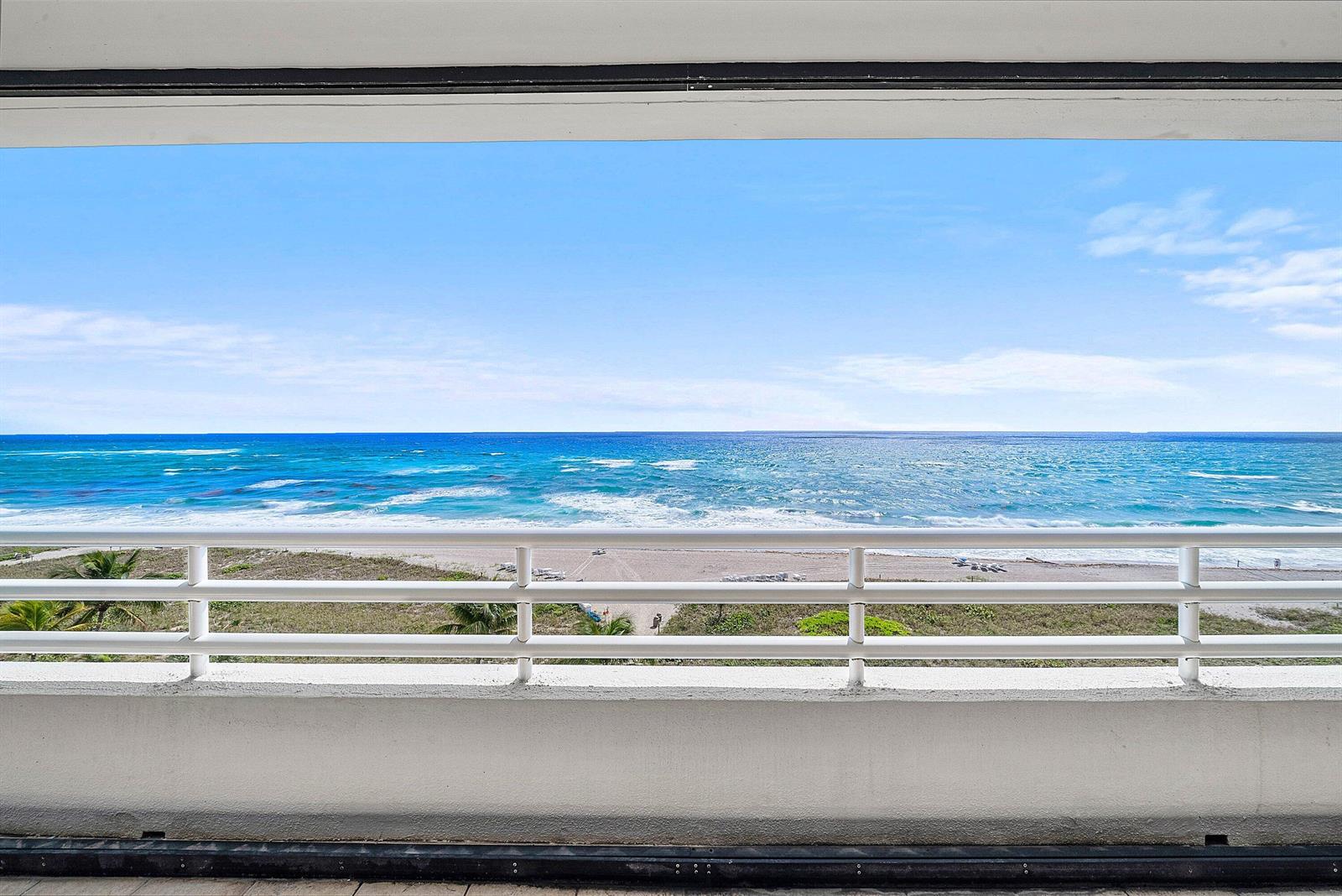 A balcony overlooks a sandy beach and the blue ocean under a clear sky — 1500 S Ocean Boulevard # 604, Boca Raton FL 33432, BOCA RATON, FL
