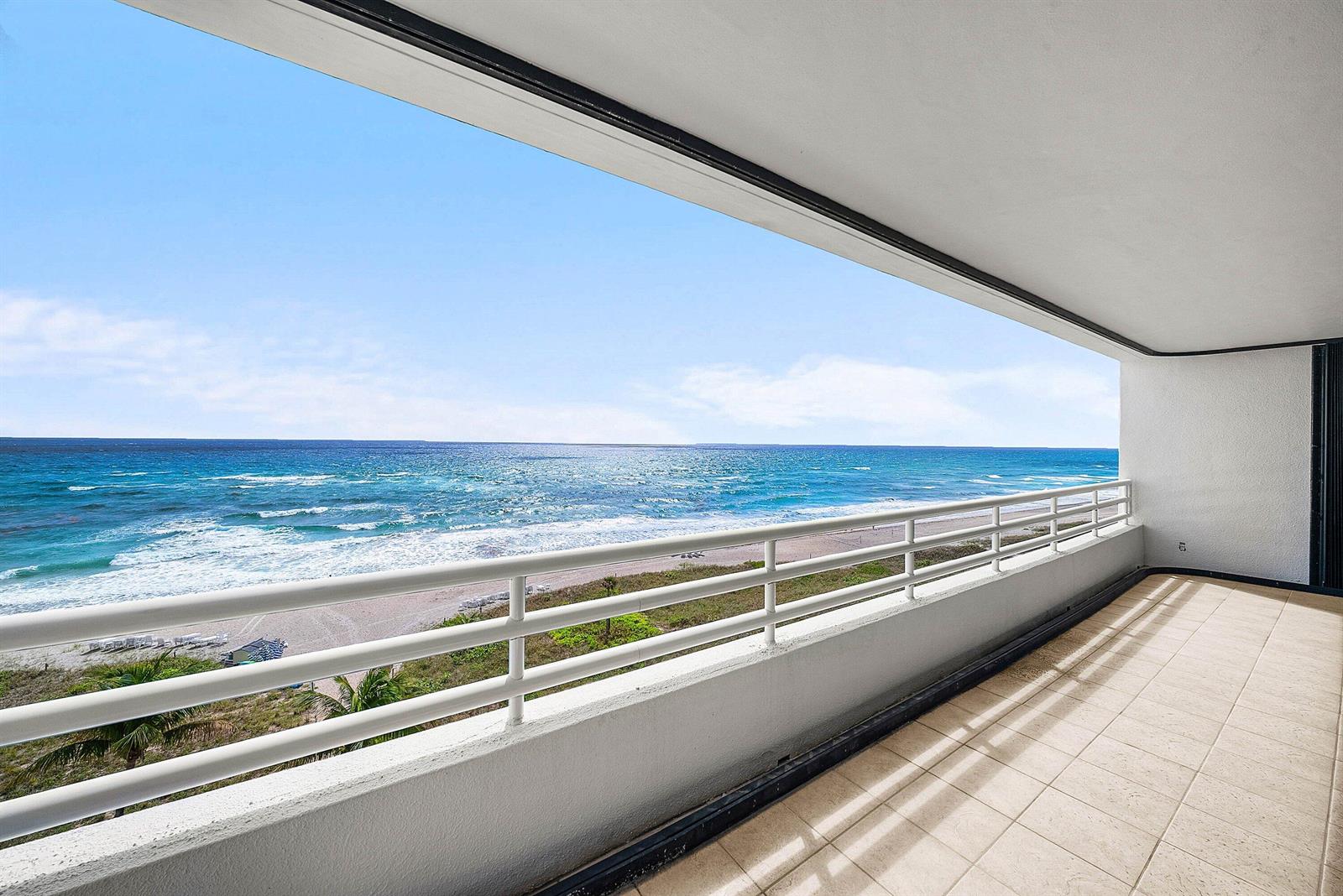 A tiled balcony overlooks a sandy beach and the ocean with a white railing — 1500 S Ocean Boulevard # 604, Boca Raton FL 33432, BOCA RATON, FL