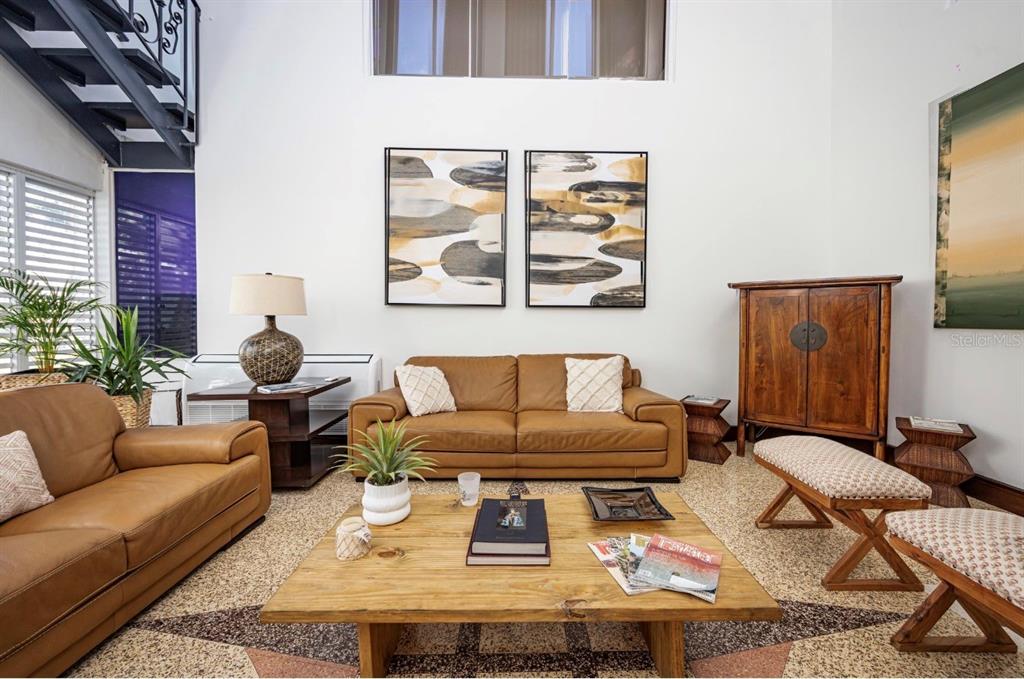 A living room features two leather sofas, a wooden coffee table, and high ceilings — 1375 MARGINAL VILLAMAR, CAROLINA, PR