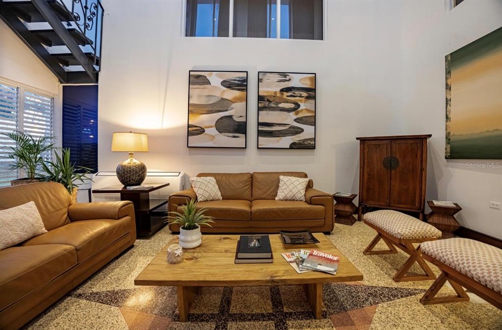 A living room features leather sofas, a wooden coffee table, and patterned terrazzo flooring — 1375 MARGINAL VILLAMAR, CAROLINA, PR