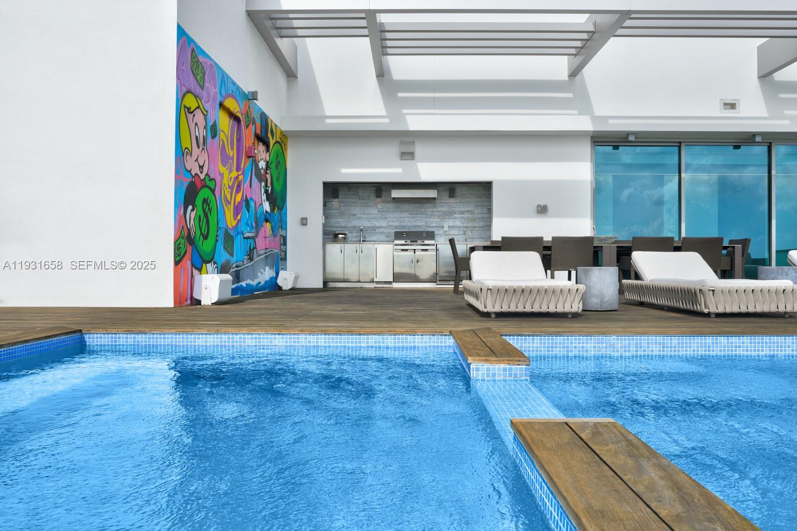 A rooftop terrace features a swimming pool, outdoor kitchen, lounge chairs, and a colorful mural — 10203 Collins Ave # 2801, Bal Harbour FL 33154, BAL HARBOUR, FL