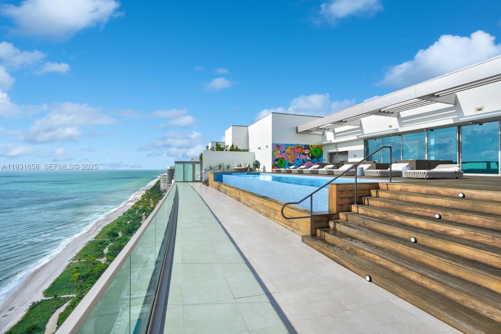 A rooftop terrace features a swimming pool, wooden stairs, and a glass railing overlooking the ocean — 10203 Collins Ave # 2801, Bal Harbour FL 33154, BAL HARBOUR, FL