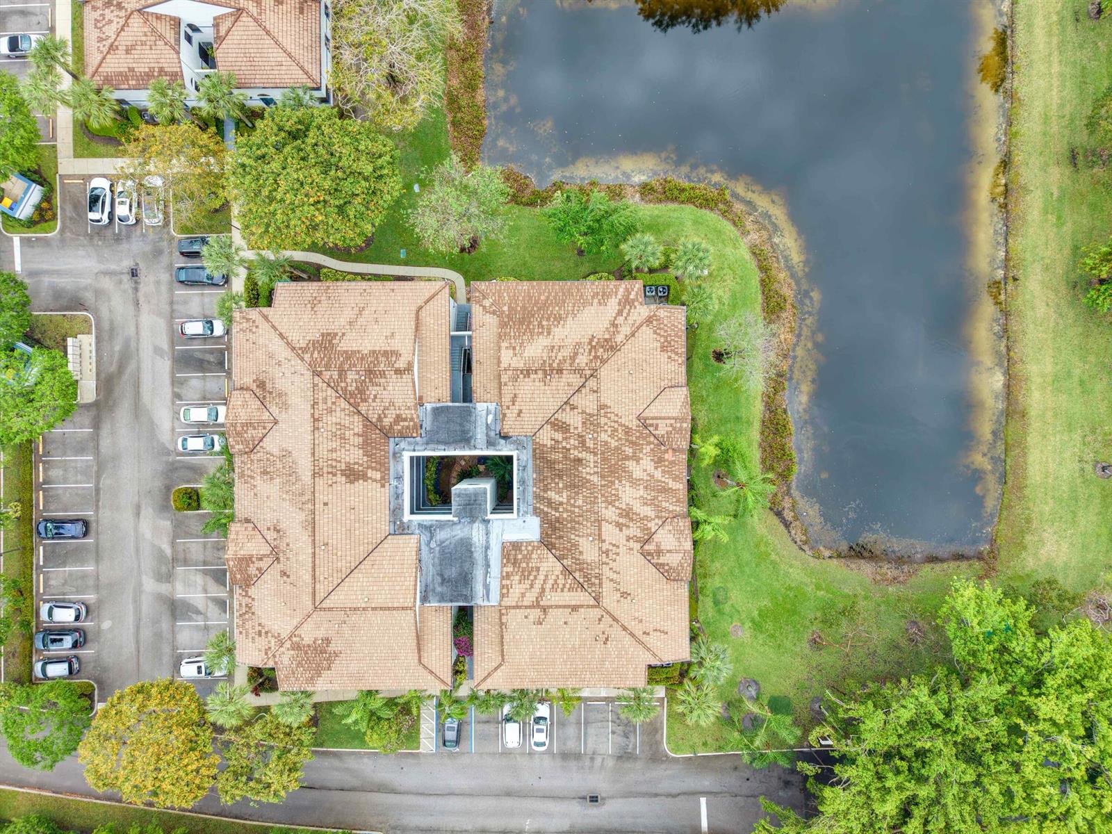 An aerial view shows a multi-story building with a central courtyard and surrounding parking lots — 5265 Brisata Circle # P, Boynton Beach FL 33437, BOYNTON BEACH, FL