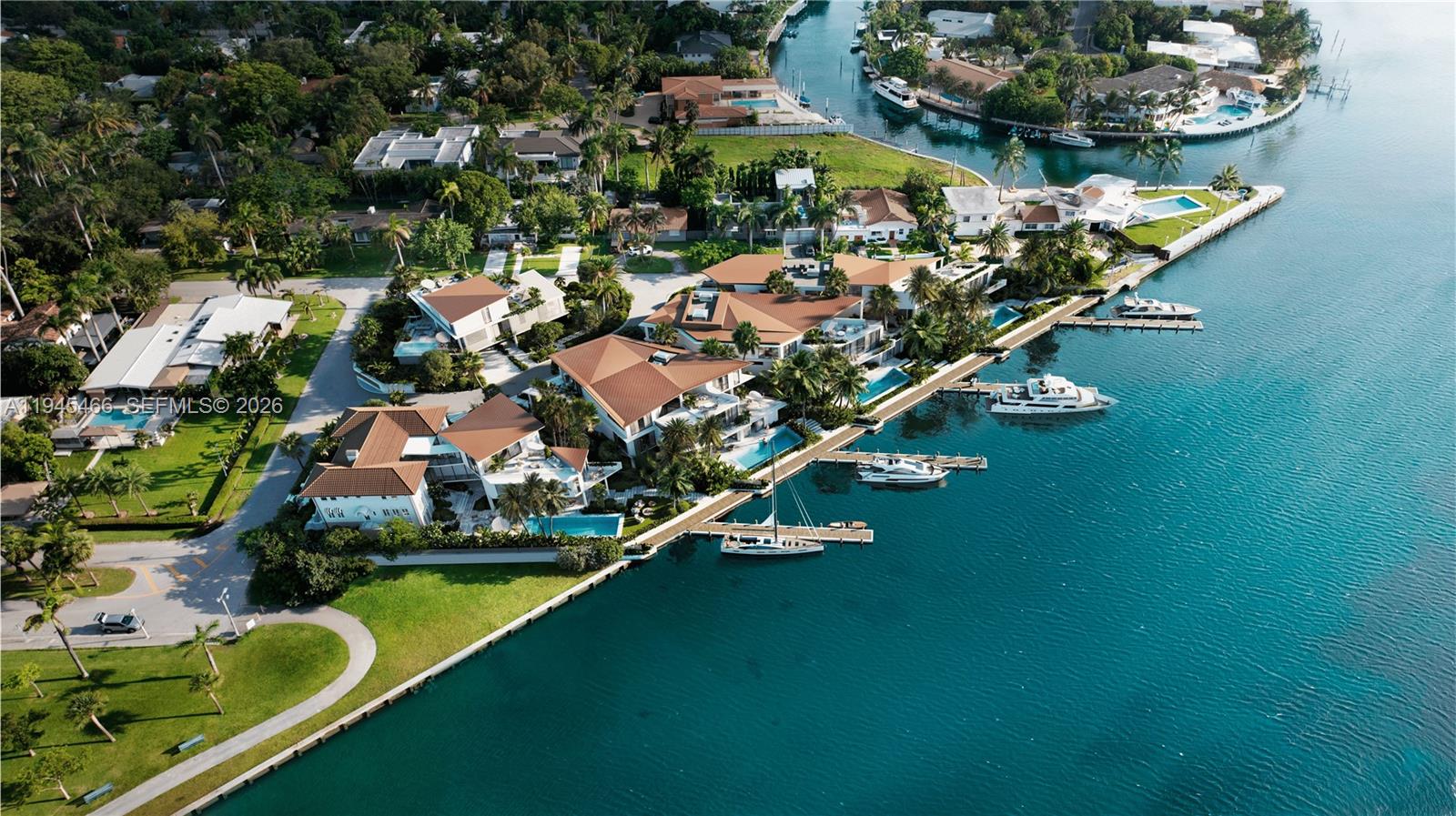 An aerial view shows several waterfront houses with pools and private docks along a canal — 7115 NE 10th Ave, Miami FL 33138, MIAMI, FL