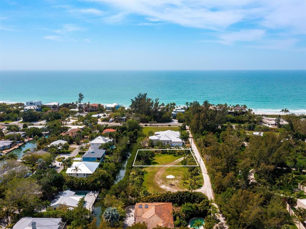 An aerial view shows a vacant, rectangular lot situated near a beach and ocean — 6608 GULF OF MEXICO DRIVE, LONGBOAT KEY, FL
