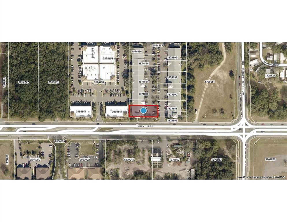 This is an aerial map showing property parcel boundaries and building locations along a highway — 757 HWY  466 UNIT 100, LADY LAKE, FL