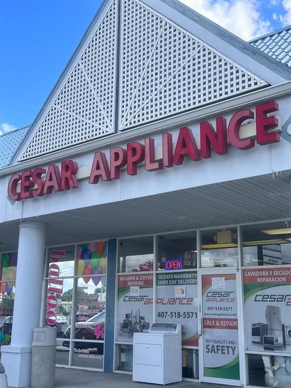 The exterior of a retail storefront features a large red sign reading Cesar Appliance — 2585 ORANGE BLOSSOM, KISSIMMEE, FL