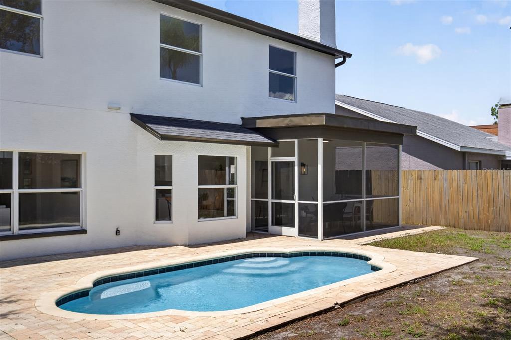 A two-story house with a screened-in patio and a swimming pool in the backyard — 11328 CLAYRIDGE DRIVE, TAMPA, FL