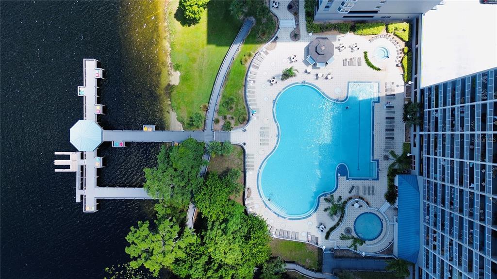 An aerial view shows a swimming pool, a hot tub, and a wooden pier — 13415 BLUE HERON BEACH DRIVE UNIT 109, ORLANDO, FL