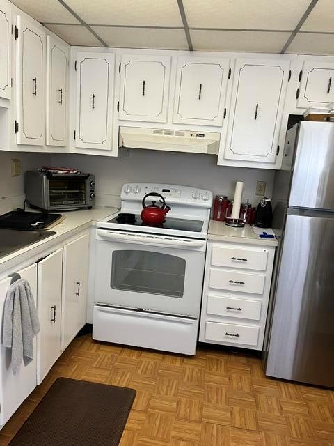 A kitchen features white cabinets, a stainless steel refrigerator, and a white stove — 351 Capri H # 351, Delray Beach FL 33484, DELRAY BEACH, FL
