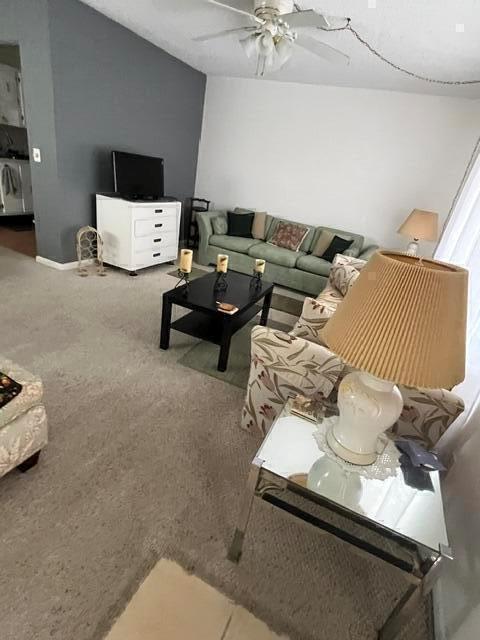 A living room features a green sofa, a black coffee table, and a mirrored side table — 351 Capri H # 351, Delray Beach FL 33484, DELRAY BEACH, FL