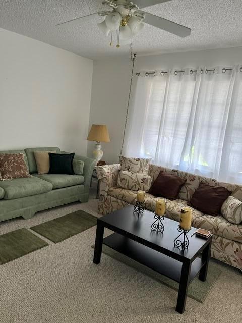 A living room features two sofas, a black coffee table, and a ceiling fan — 351 Capri H # 351, Delray Beach FL 33484, DELRAY BEACH, FL