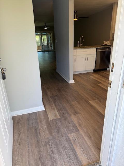 An entryway leads to a kitchen with white cabinets and wood-look flooring — 1219 S Lakes End Drive # 2, Fort Pierce FL 34982, FORT PIERCE, FL