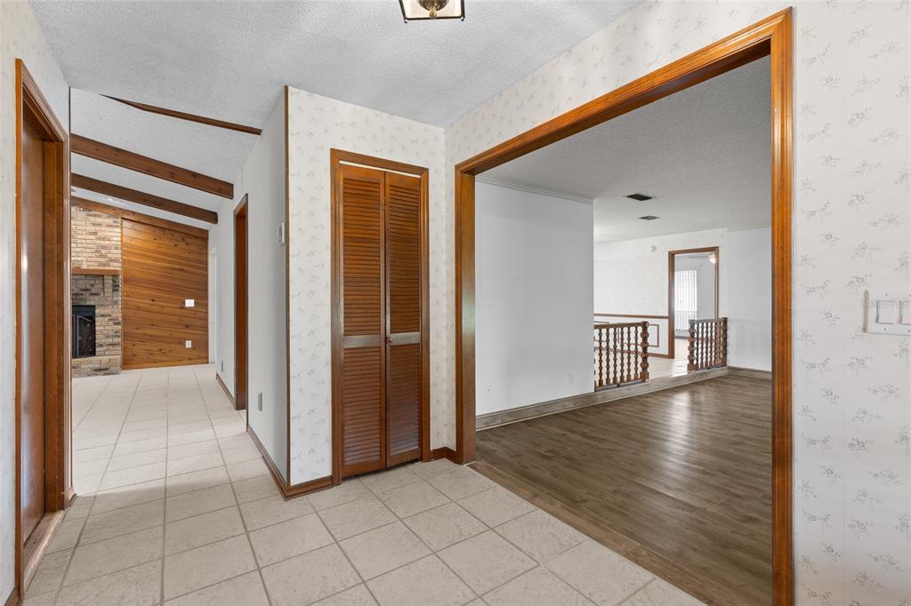 An interior view showing a tiled entryway, a wood-paneled fireplace room, and a sunken living area — 521 FERNWOOD DRIVE, ALTAMONTE SPRINGS, FL